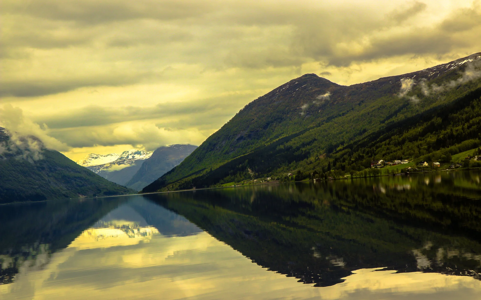 Norwegian mountain lake reflecting a dramatic evening sky